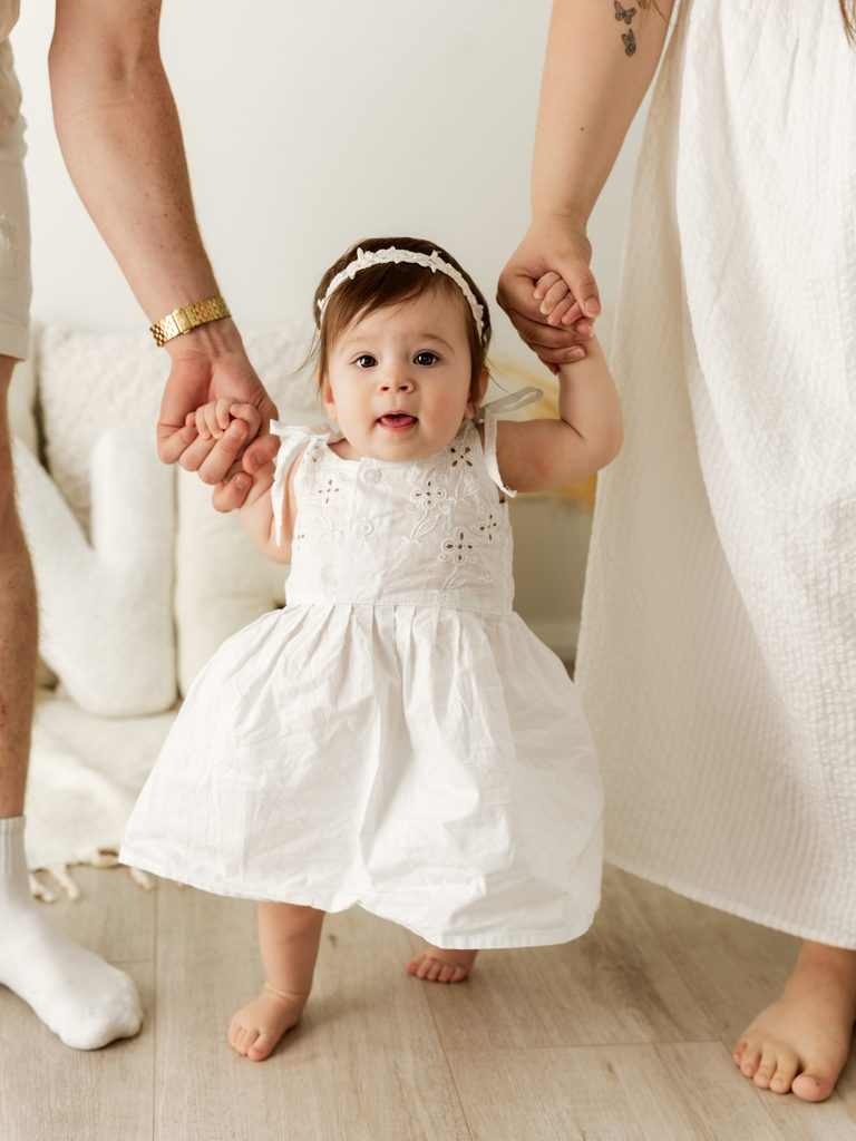 One-year-old baby smiling during a first birthday photoshoot at Four O Photography