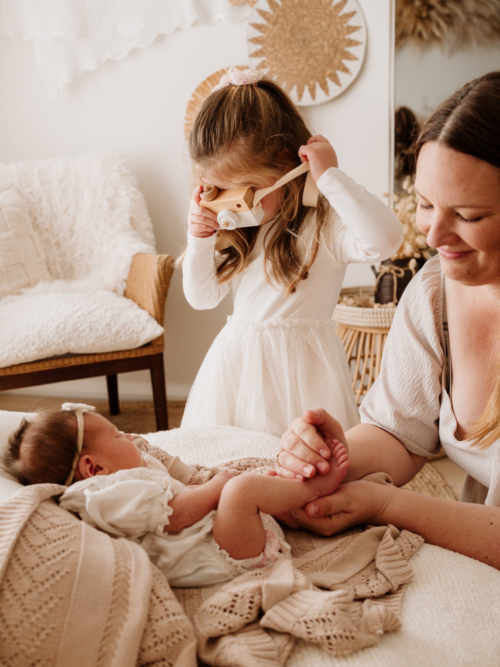 Toddler with newborn baby and mum during a newborn photography session in Hilbert Perth